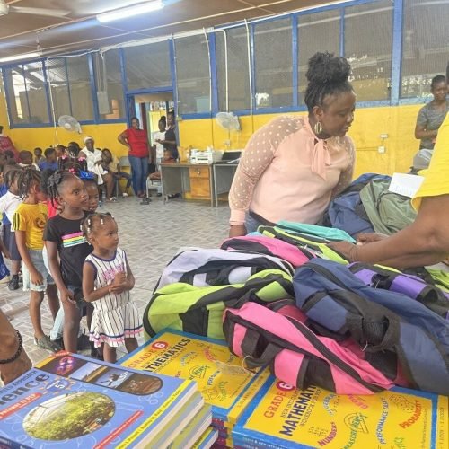 Love of Hearts Foundation Back to School Drive 2025 happy students in line to receive their bag packs text books